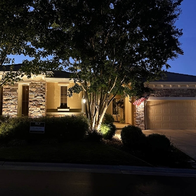 Curb appeal lighting makes the home shine after dark in Regency at Folsom Ranch. Photo